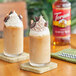 A glass of milk with Torani Almond Roca flavoring syrup in it.