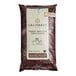 A white bag of Callebaut Recipe 811 dark chocolate callets with black text and a yellow circle logo.