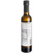 A close up of a bottle of 8.45 oz. white truffle oil with a label.