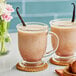Two glasses of Dona Unsweetened Masala Chai concentrate with vanilla beans.