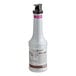 A close up of a white Monin Passion Fruit Puree bottle with a black lid.