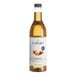 A close up of a Capora Sugar Free Caramel Flavoring Syrup bottle with a white label.