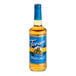 A Torani Sugar-Free Hazelnut Flavoring Syrup 750 mL glass bottle with a blue label containing liquid.