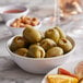 A bowl of Belosa lemon peel stuffed green olives on a table.