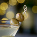 A martini with Belosa Almond Stuffed Queen Olives on a stick.