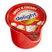 A red and white International Delight container of sweet and creamy non-dairy creamer.