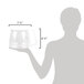 A person using a Proctor Silex clear glass coffee pot with a white handle.