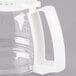 A clear glass coffee pot with a white handle.