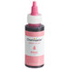 A Chefmaster bottle of pink oil-based food coloring.