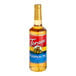 A Torani Pumpkin Pie flavoring syrup 750 mL glass bottle with a red label.