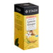 A white and yellow box of Stash Lemon Ginger Herbal Tea Bags.