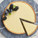 A slice of pie with blackberries and blueberries topped with melted Guittard white chocolate.