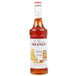 A bottle of Monin Premium Honey Syrup with a white label.