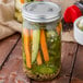 A close-up of a Morton jar filled with pickled vegetables.