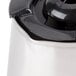 A Hamilton Beach stainless steel coffee pot with a lid.