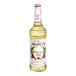 A Monin Premium Pure Cane Syrup bottle with a white label.