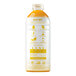 A white plastic bottle of Smartfruit Mellow Mango Puree with yellow text on the label containing orange liquid.