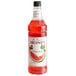 A bottle of Monin watermelon syrup with a red liquid and a Monin label.