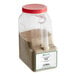 A plastic container of brown granulated onion powder with a lid.