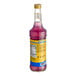 A close-up of a bottle of purple Monin Sugar-Free Lavender flavoring syrup.