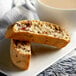 A plate of biscotti next to a cup of coffee.
