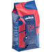 A blue, red, and white bag of Lavazza Top Class Whole Bean Espresso Coffee.