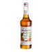 A bottle of Monin Premium Pumpkin Spice Flavoring Syrup, 750 mL.