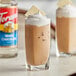 Two glasses of iced coffee with whipped cream and Torani White Chocolate syrup.