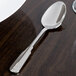 A Oneida Cityscape stainless steel oval bowl soup/dessert spoon on a table.