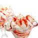 Two glass bowls of strawberry ice cream with a red and white swirl.