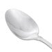 A Oneida Rosewood stainless steel teaspoon with a silver handle.