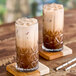 Two glasses of Tiki Breeze Coffee Pop Energy on a table.