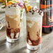 Two glasses of ice cream with DaVinci Gourmet Classic Tiramisu syrup and chocolate toppings on a table.