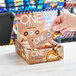 A hand holding a package of ONE Coffee Shop Vanilla Latte Protein Bars.