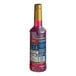 A Torani Pomegranate Flavoring Syrup bottle with a red liquid and a gold lid.