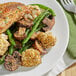 A plate of chicken, mushrooms, and green beans seasoned with Dash Salt-Free Original Seasoning.