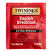 A red and white Twinings English Breakfast Extra Strong tea bag packet.