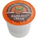A white container of Caffe de Aroma Hazelnut Cream coffee single serve cups with an orange label.