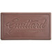 A brown rectangular Guittard French Vanilla chocolate bar with writing on it.