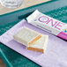 A white tray with six white and orange ONE Fruity Cereal Protein Bars.