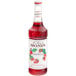 A Monin bottle of strawberry syrup filled with red liquid.