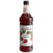 A bottle of Monin Premium Wild Strawberry flavoring syrup with a label.