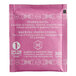 A pink Harney & Sons tea packet with white text containing raspberry herbal tea bags.