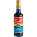 A Torani Blue Raspberry syrup plastic bottle with a red label.