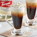 A glass of coffee flavored with Torani Puremade Diamond syrup on a table.