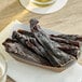 A table with a basket of Wild Bill's hickory-smoked beef jerky and a bowl of meat.
