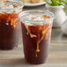 Two cups of Toddy cold brew coffee with ice on a table.