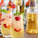 Two glasses of Finest Call white sangria with fruit and mint on the side.