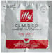 A close up of an illy Classico single serve espresso pod in a packet.