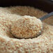 A spoonful of minced onion sitting in a bowl of oats.